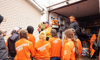 Teen volunteers getting instructions for hurricane cleanup
